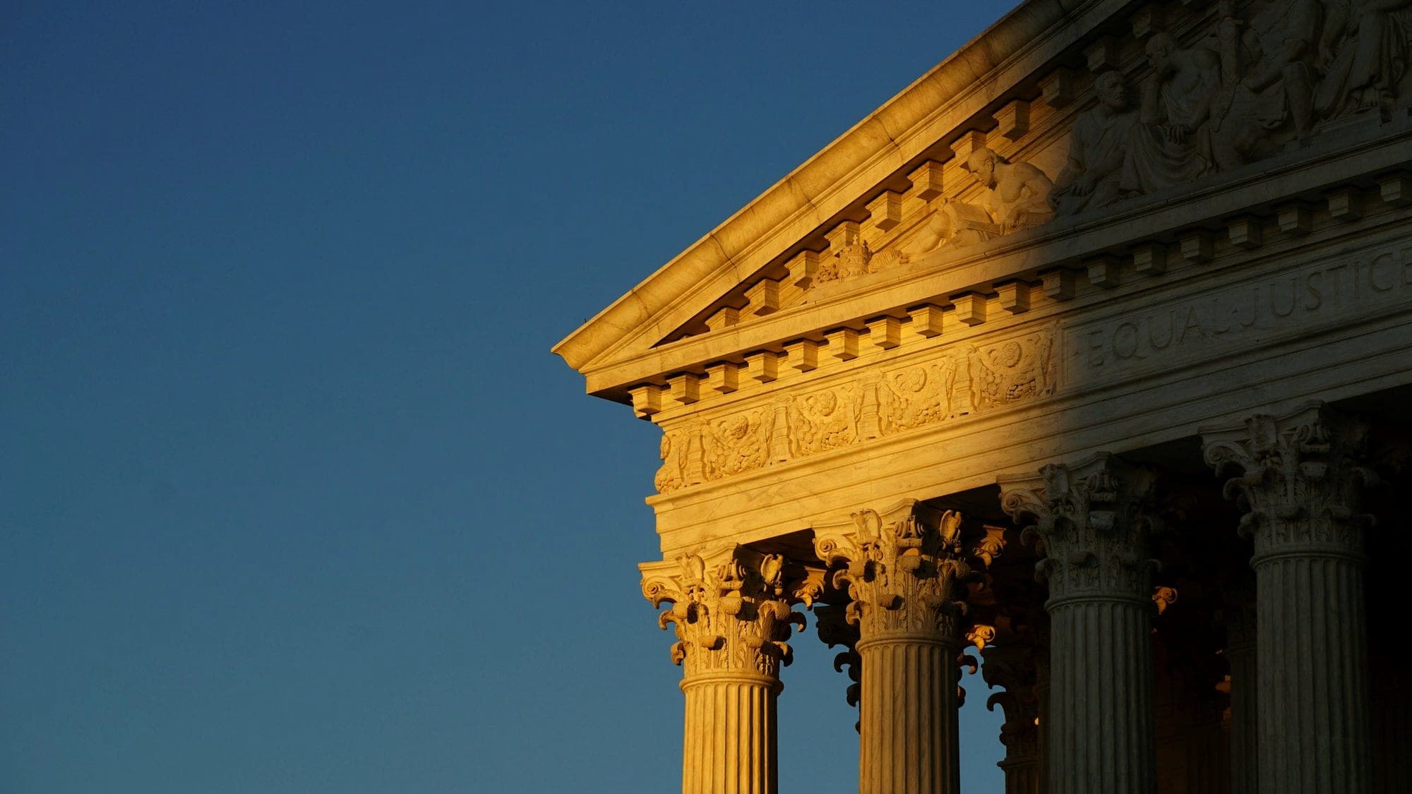The columns of a courthouse in late sun